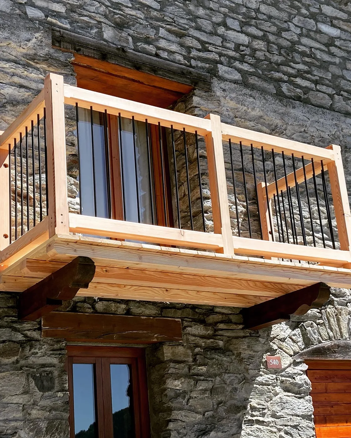 Solid larch balcony with black steel balustrade, Les Laix